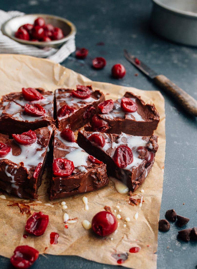 chocolate covered cherry fudge on brown parchment paper cut into wedges