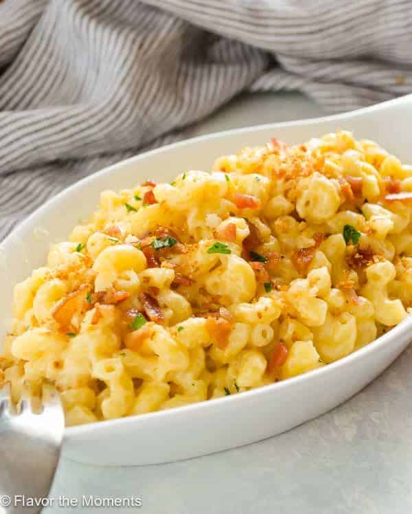 one pot stovetop macaroni and cheese in white bowl with grey towel in the background