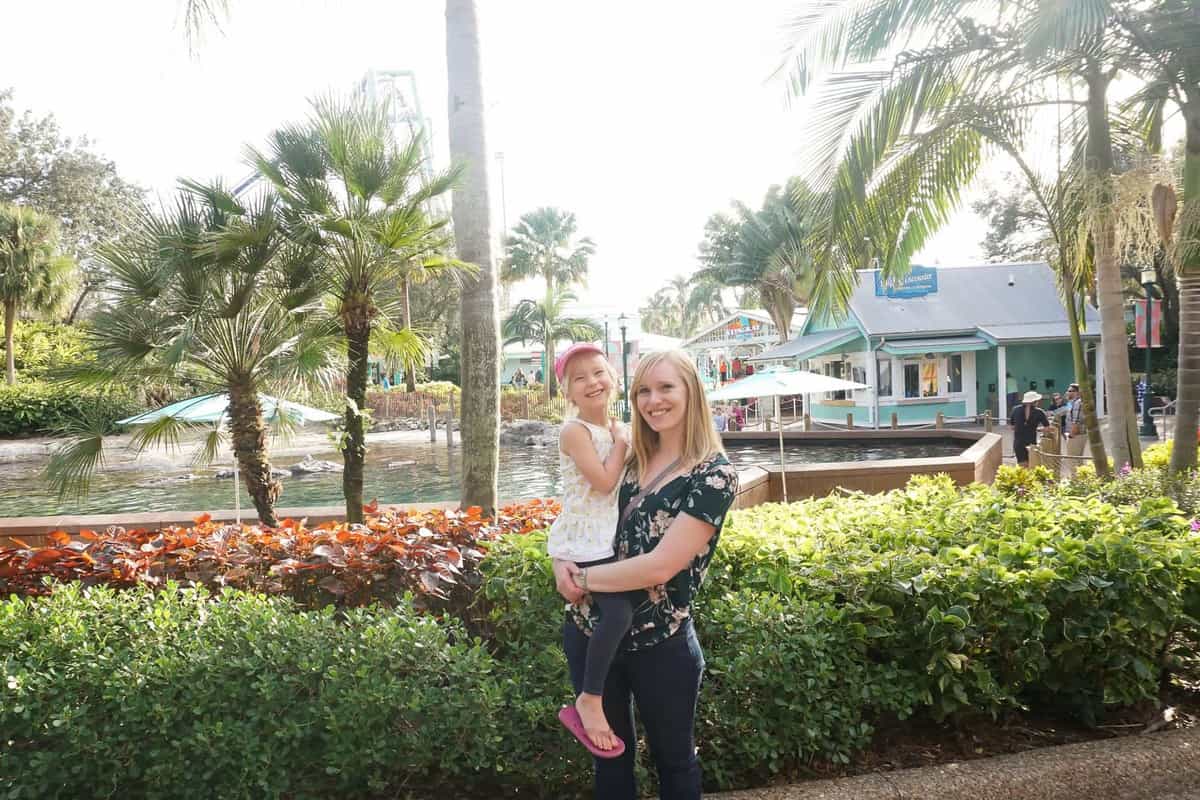 mom and daughter in front of water feature in seaworld orlando