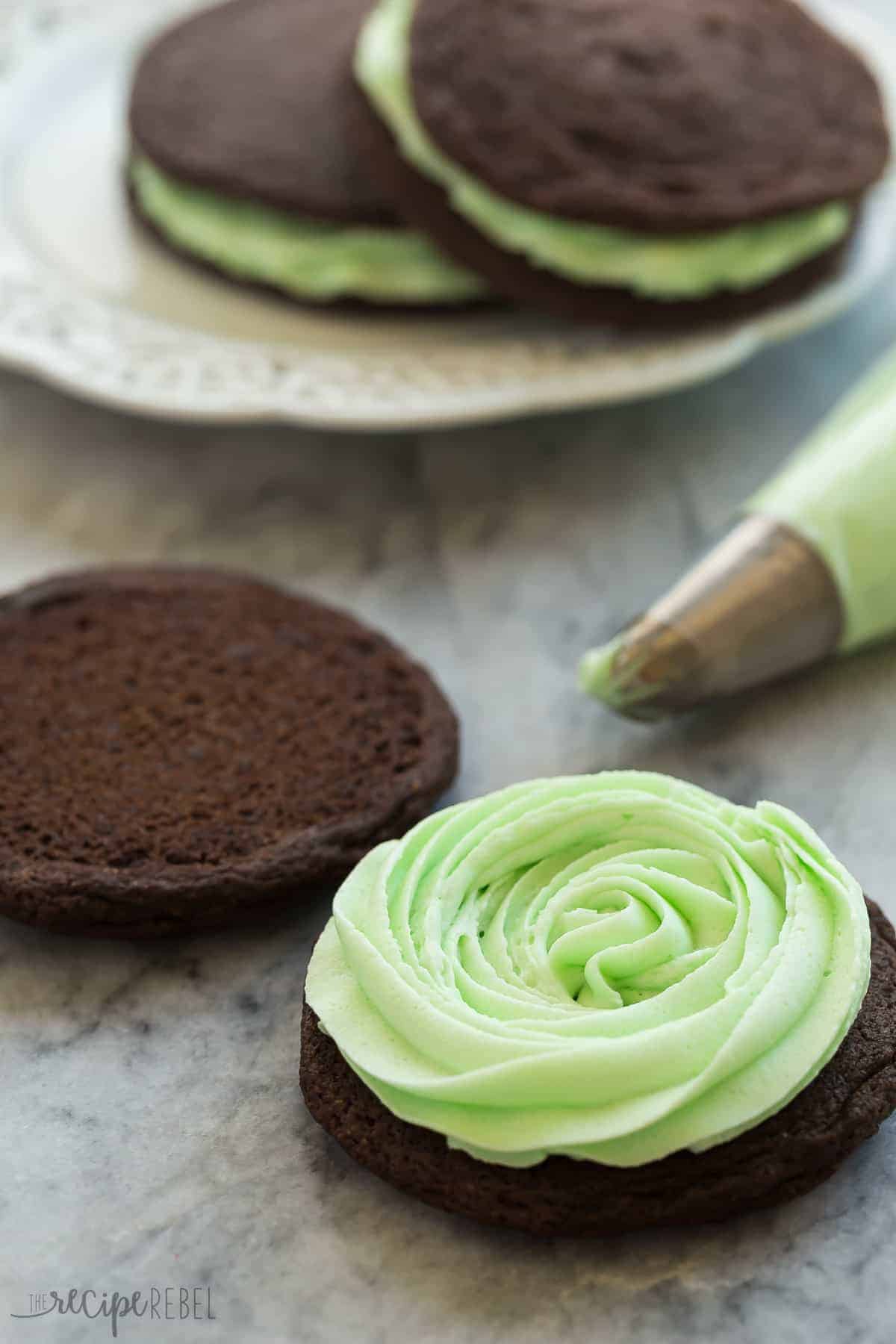 one chocolate cookie with mint frosting piped onto it