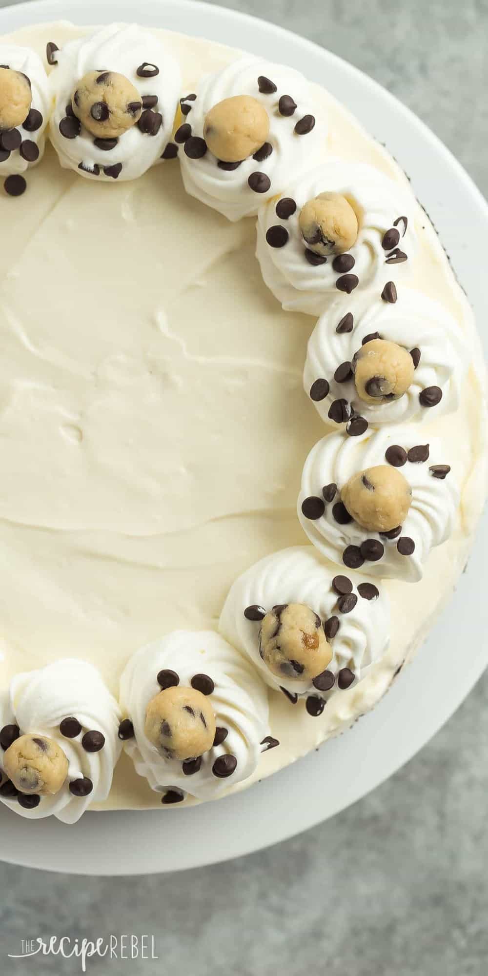 tall image of no bake cookie dough cheesecake overhead with mini chocolate chips and cookie dough balls