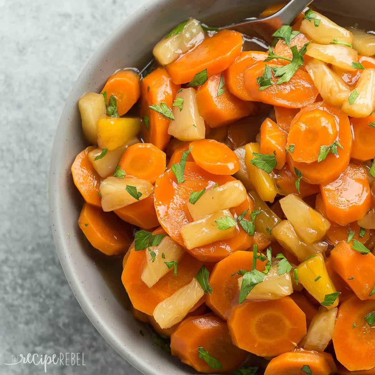 square image of grey bowl filled with pineapple glazed carrots