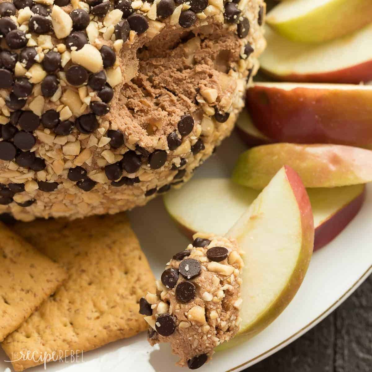 snickers cheese ball spread on apple slice on plate