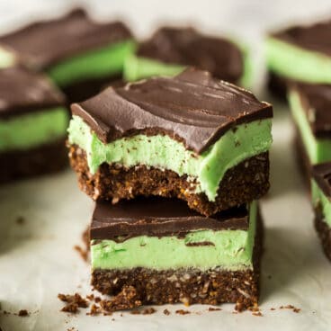 two mint bars stacked with a bite taken out of the top bar