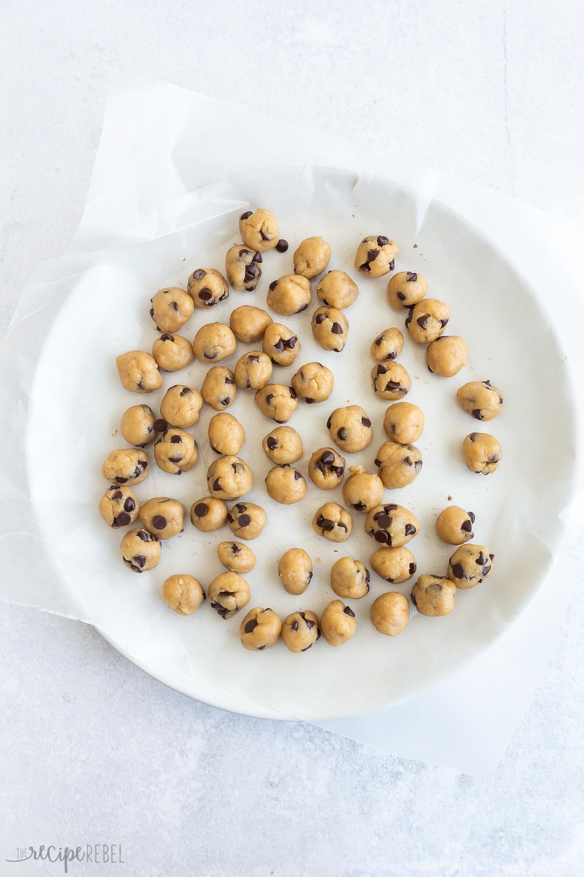 unbaked cookie dough balls on a plate.