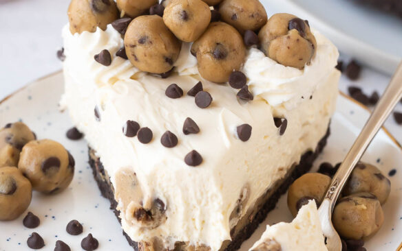 one piece of cookie dough cheesecake with bite missing.