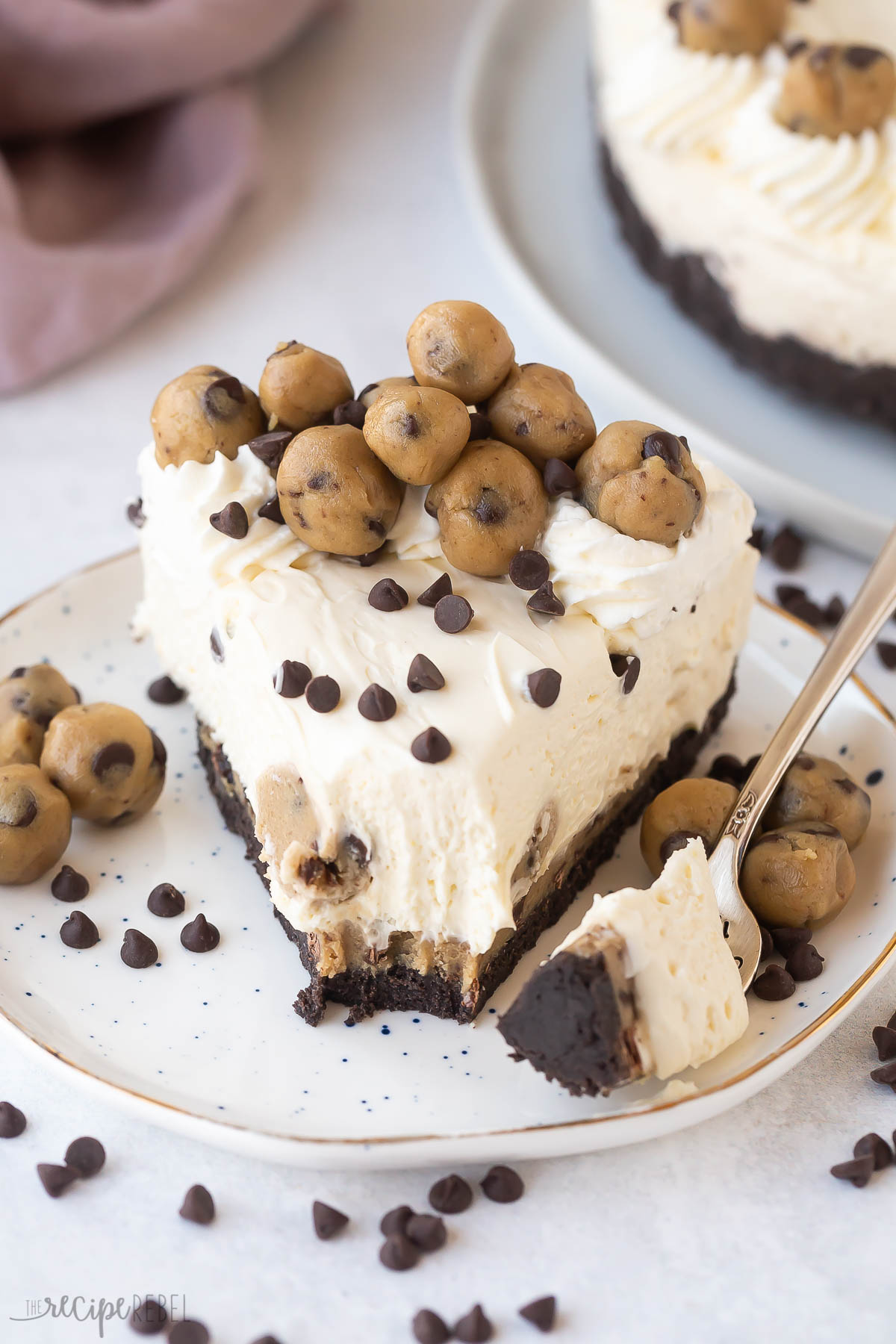 one piece of cookie dough cheesecake with bite missing.