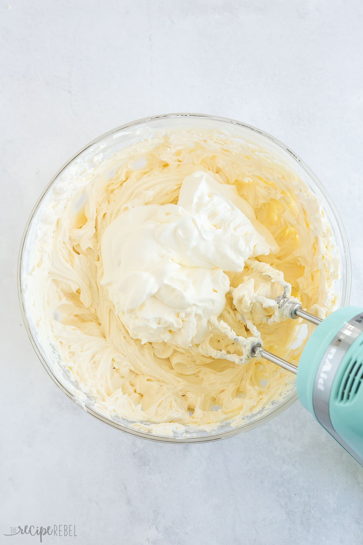 cream cheese filling with whipped cream added to bowl.