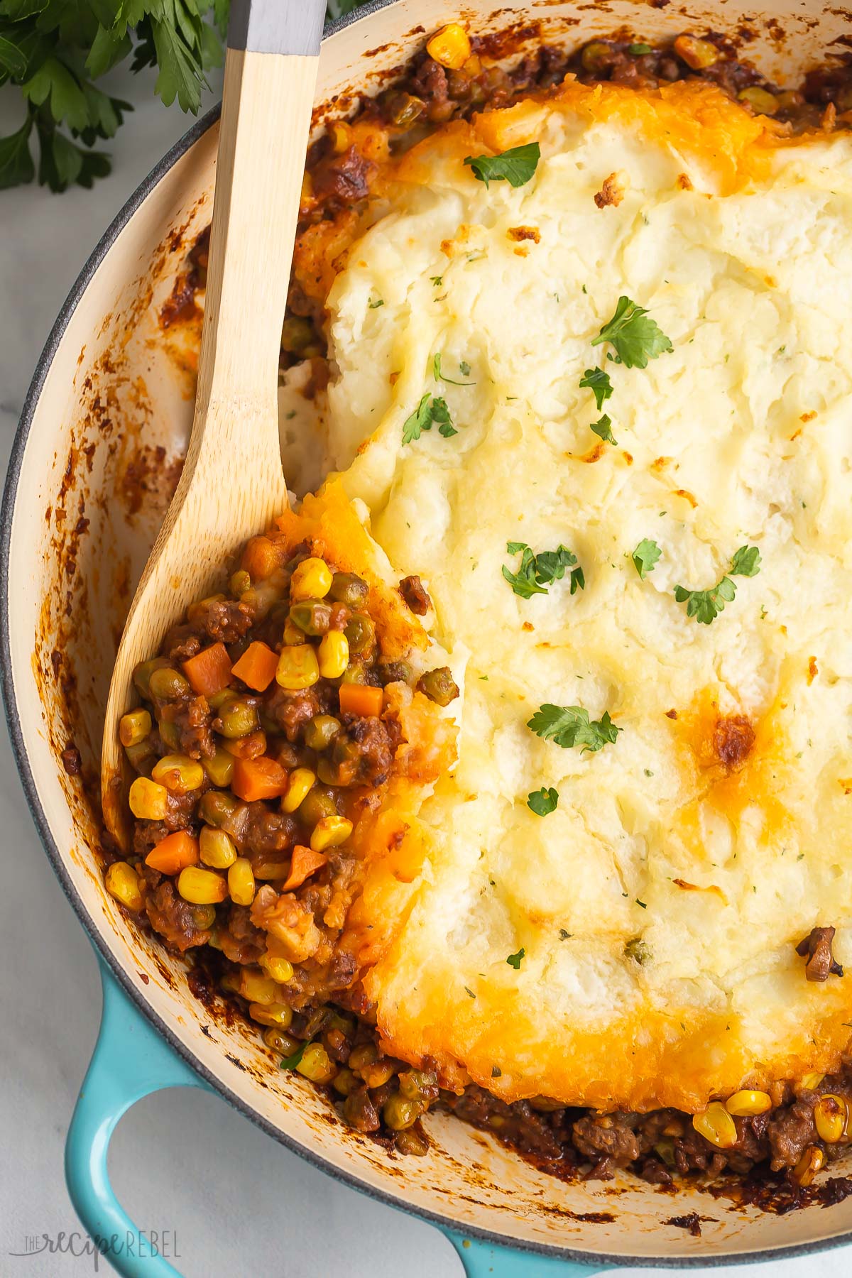 wooden spoon scooping shepherds pie.