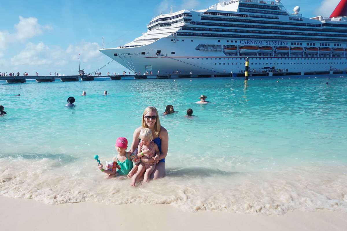 mom and two girls in grand turk beach in front of carnival sunshine
