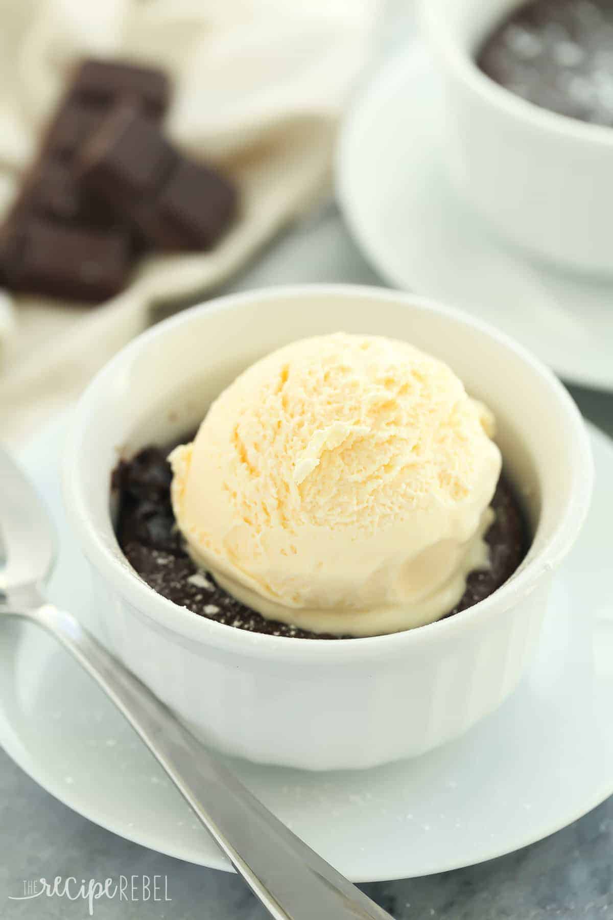 ramekin of chocolate cake with scoop of vanilla ice cream on top