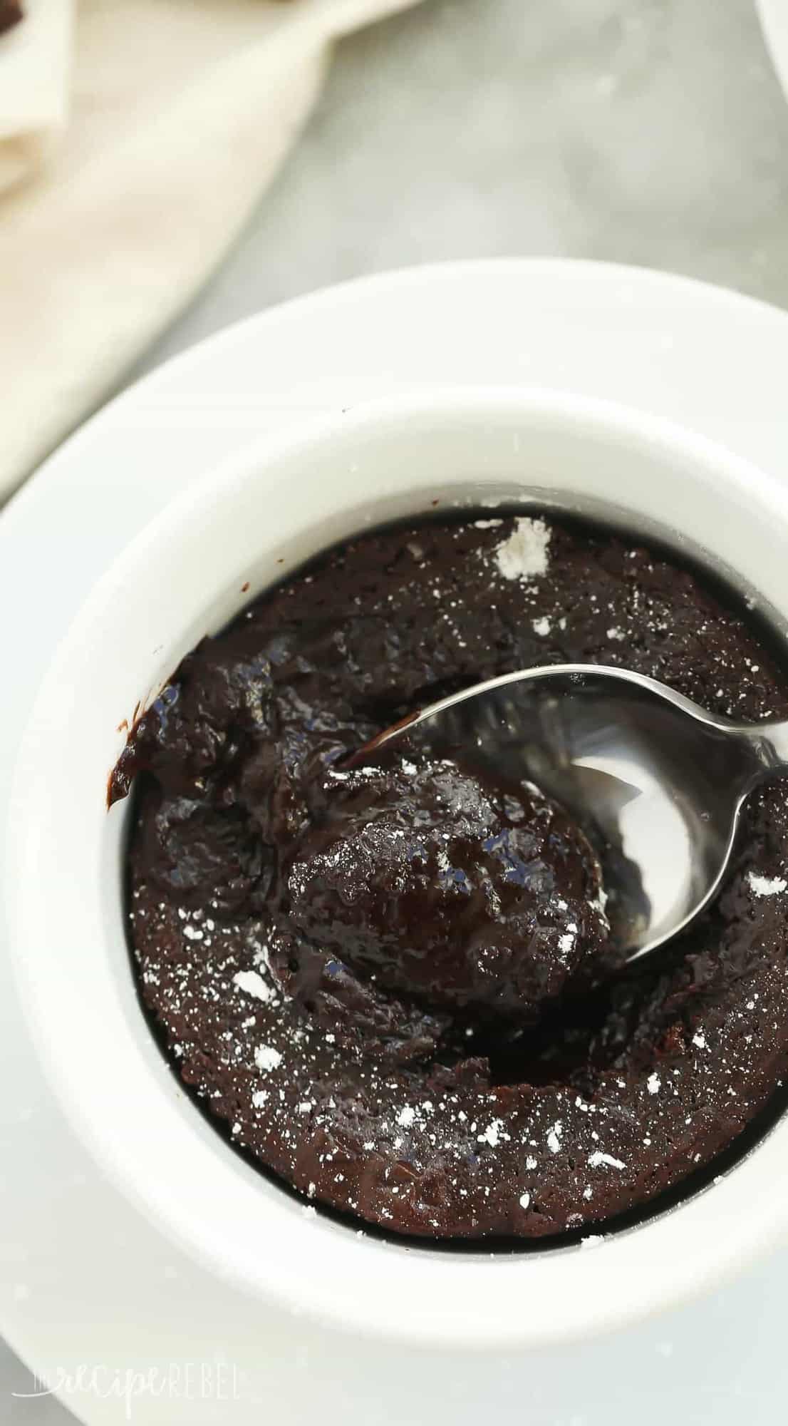overhead image of ramekin of melting chocolate cake with spoon stuck in