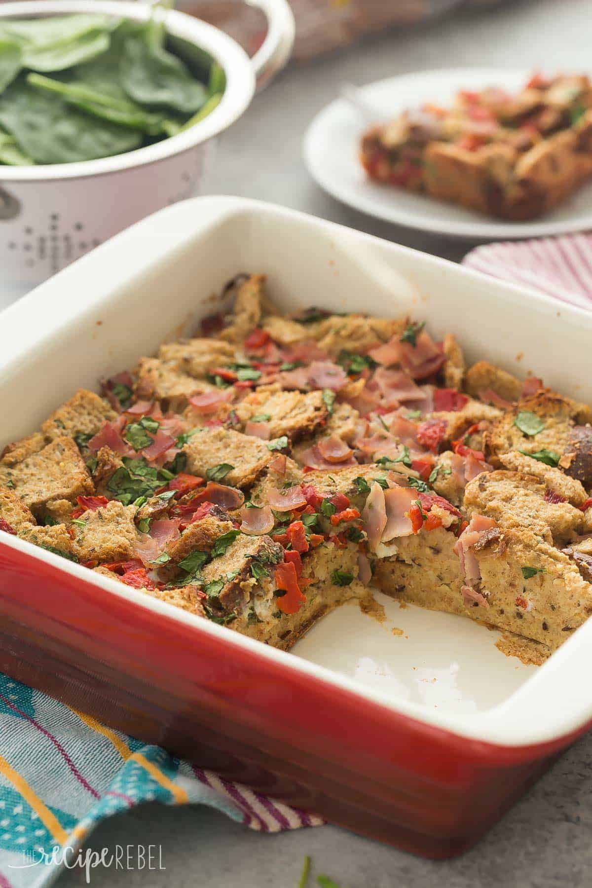 pan of spinach and ham breakfast casserole with one piece cut out