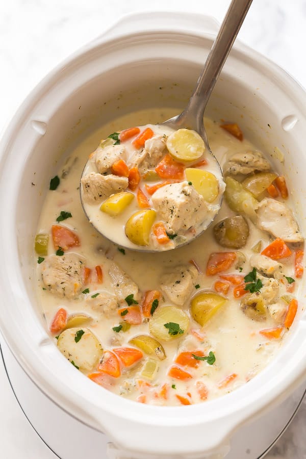 slow cooker with garlic parmesan chicken stew in it and a metal ladle