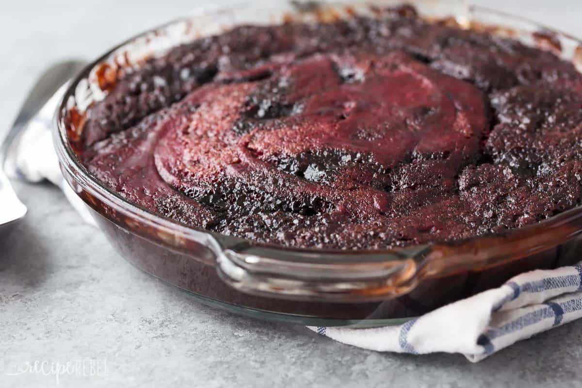 pan of red velvet pudding cake whole on a grey background