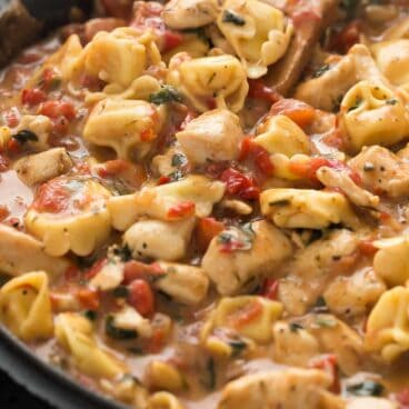 This Italian Chicken Tortellini Skillet is an en easy meal made completely in one pot -- loaded with roasted red peppers, spinach, tomatoes, herbs and cheese!