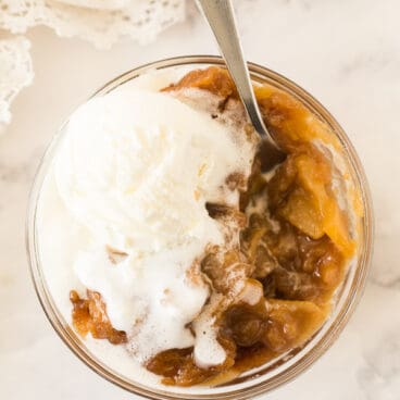 overhead image of caramel apple pudding cake with ice cream melting over