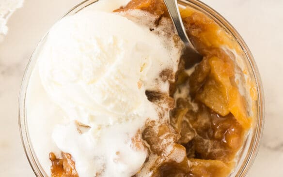 overhead image of caramel apple pudding cake with ice cream melting over