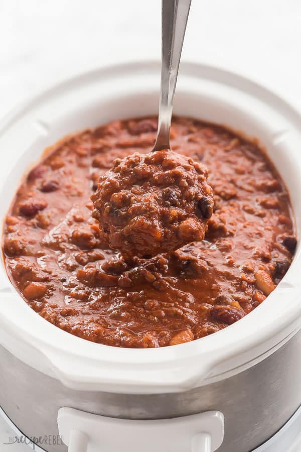 slow cooker chili in white crockpot with metal scoop