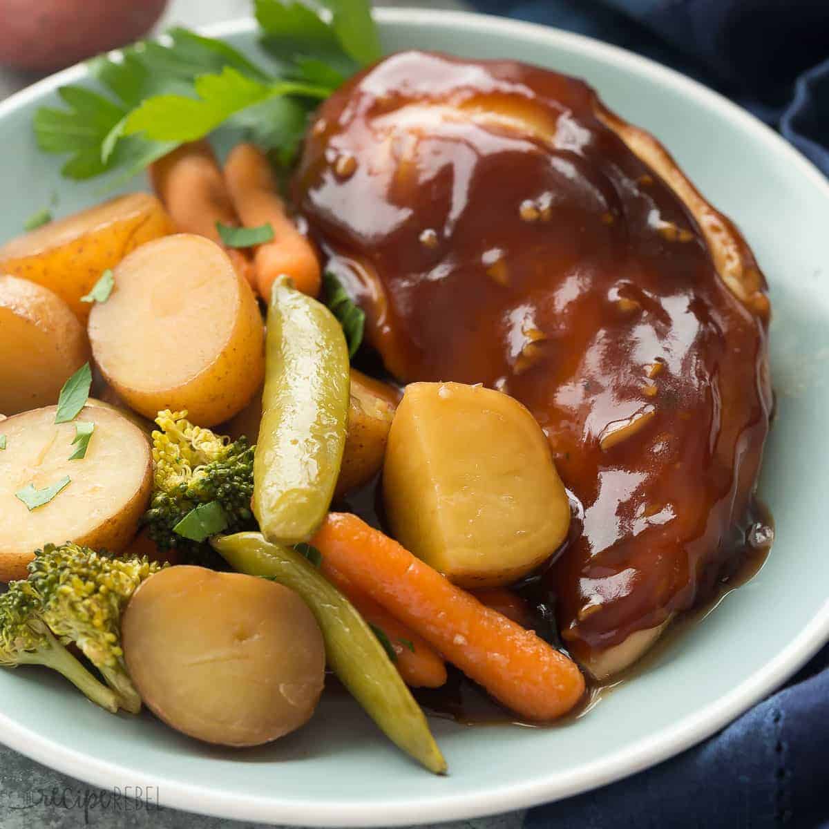 square image of honey garlic chicken breast and vegetables on a blue plate