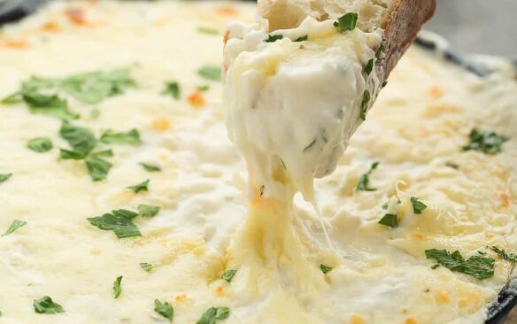 This Cheesy Chicken Alfredo Dip is perfect for game day, movie night, an appetizer or a casual dinner! It’s creamy, cheesy, and made from scratch! Perfect with crusty bread or vegetables.