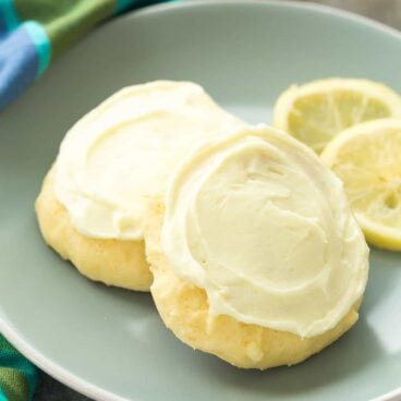 These Lemon Sour Cream Sugar Cookies are soft, moist and loaded with lemon! There's no chilling or rolling -- just stir, drop, bake and frost (if you want to!). Perfect for Easter or Christmas baking. | lemon cookies | easy cookie recipe | Christmas cookies | sour cream cookies