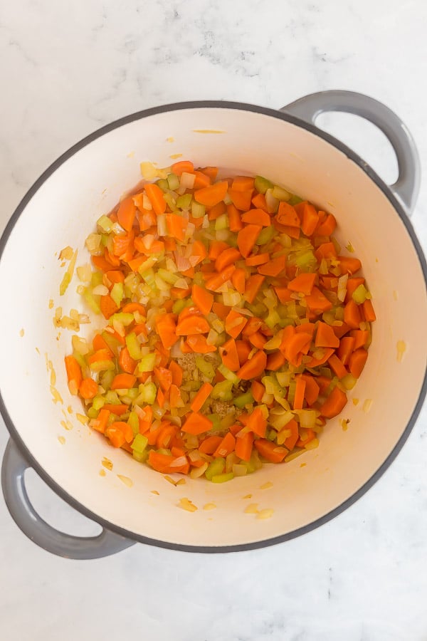 carrots onions and celery cooking in large dutch oven