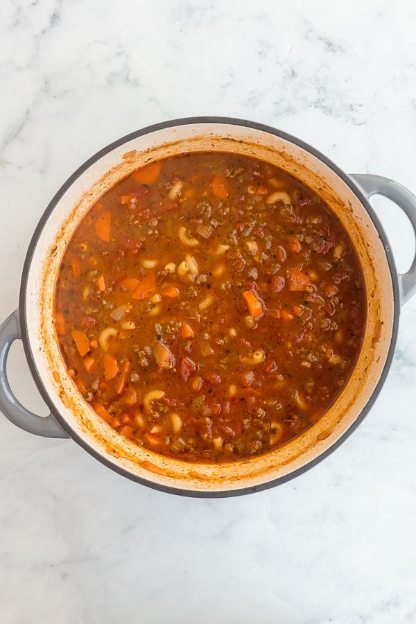 dry macaroni noodles added to tomato macaroni soup