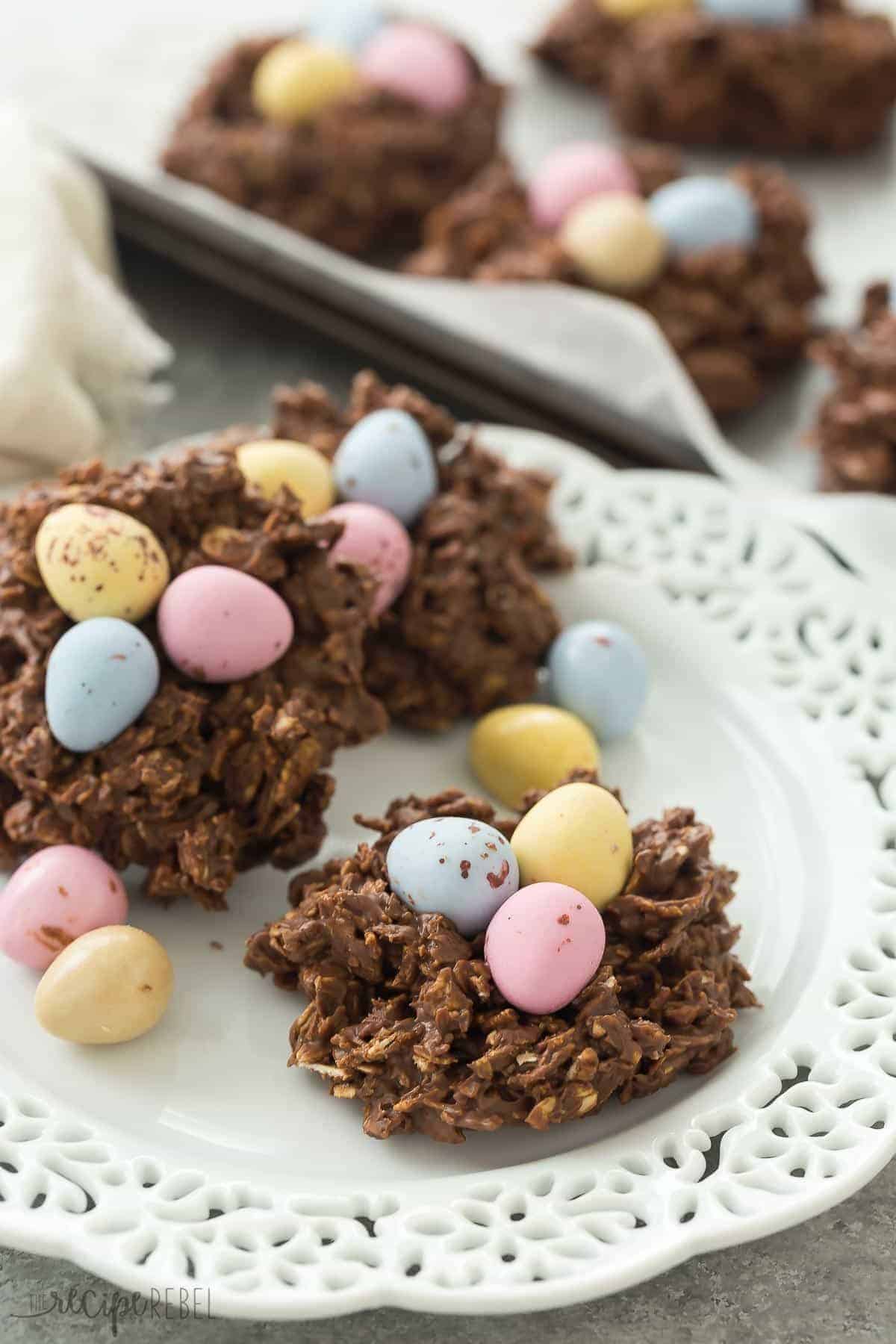 no bake birds nest cookies on white plate with pink blue and yellow mini eggs