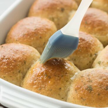 Homemade dinner rolls that are easier than you think, with a step by step recipe video and tons of garlic herb flavor! They're perfectly soft and fluffy. Includes how to recipe video