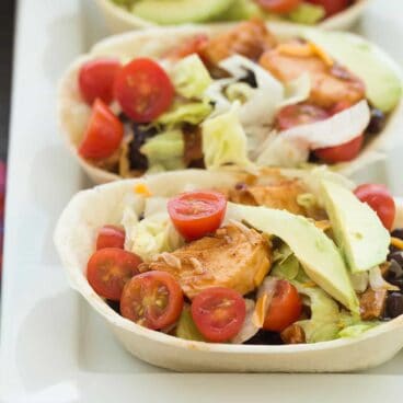 These BBQ Chicken Taco Bowls are an easy make ahead meal -- freezer friendly and perfect for your week's meal prep! The chicken can be made on the stovetop, in the slow cooker or Instant Pot. Includes step by step recipe video. | meal prep | make ahead | freezer | low calorie | healthy meal | dinner recipe | easy recipe | chicken recipe