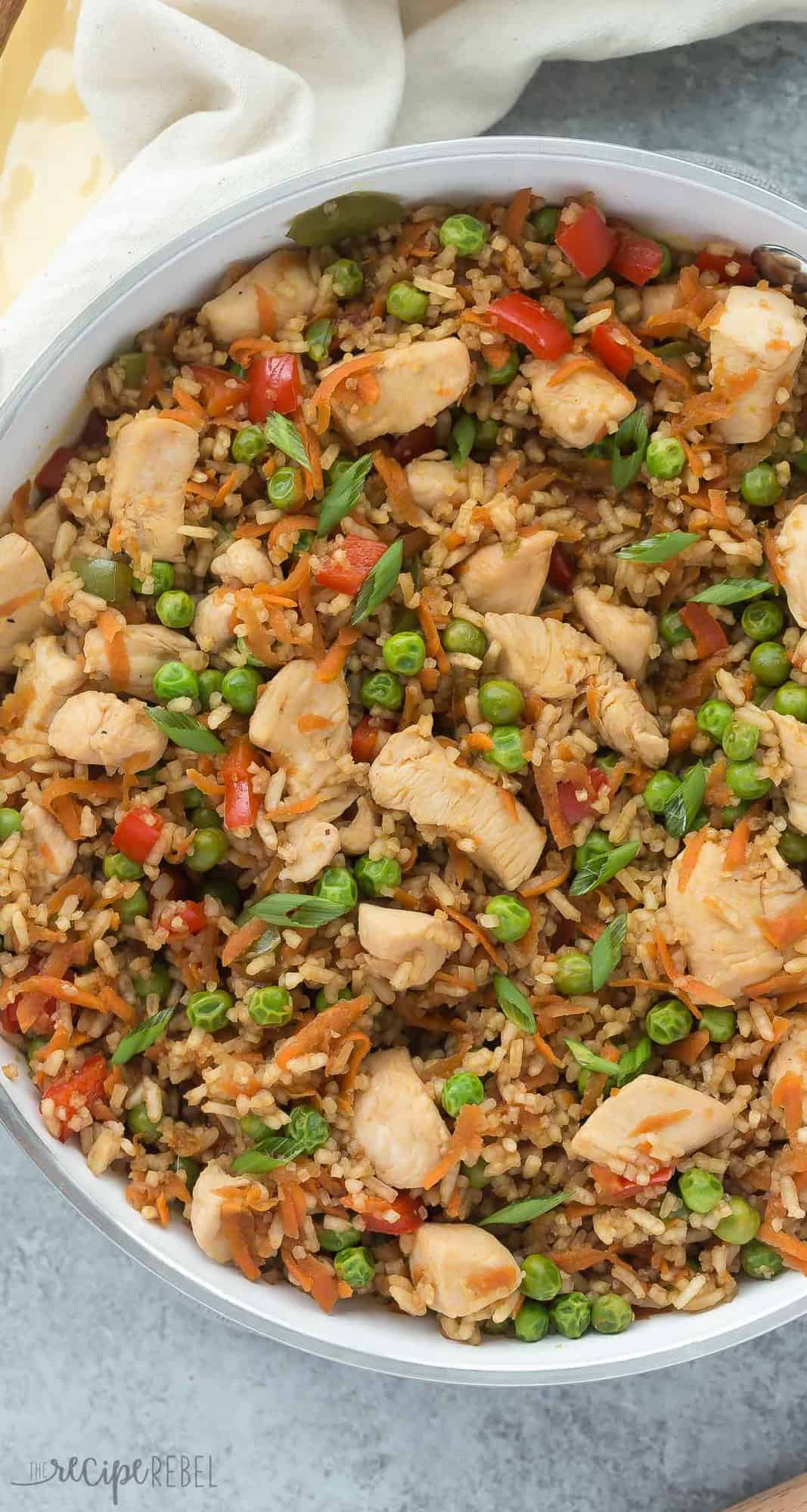 one pot teriyaki chicken rice and vegetables overhead in white skillet on grey background