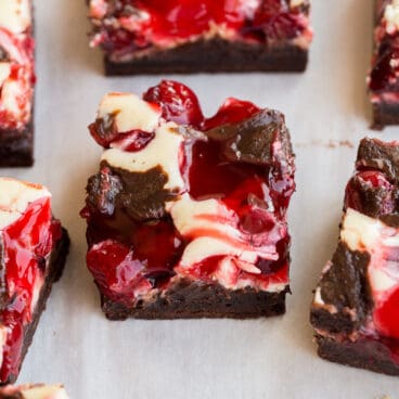 close up image of cherry cheesecake brownie on parchment