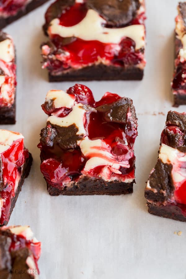 close up image of cherry cheesecake brownie on parchment