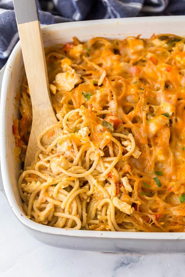 close up of spoon scooping chicken spaghetti in pan