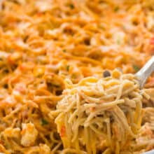 chicken spaghetti being scooped out of pan