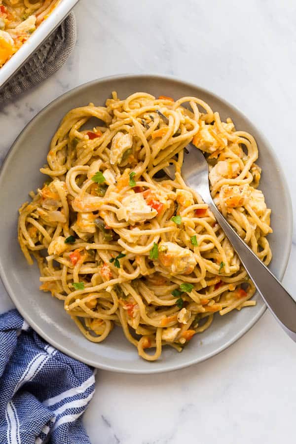 plate of chicken spaghetti with fork stuck in noodles