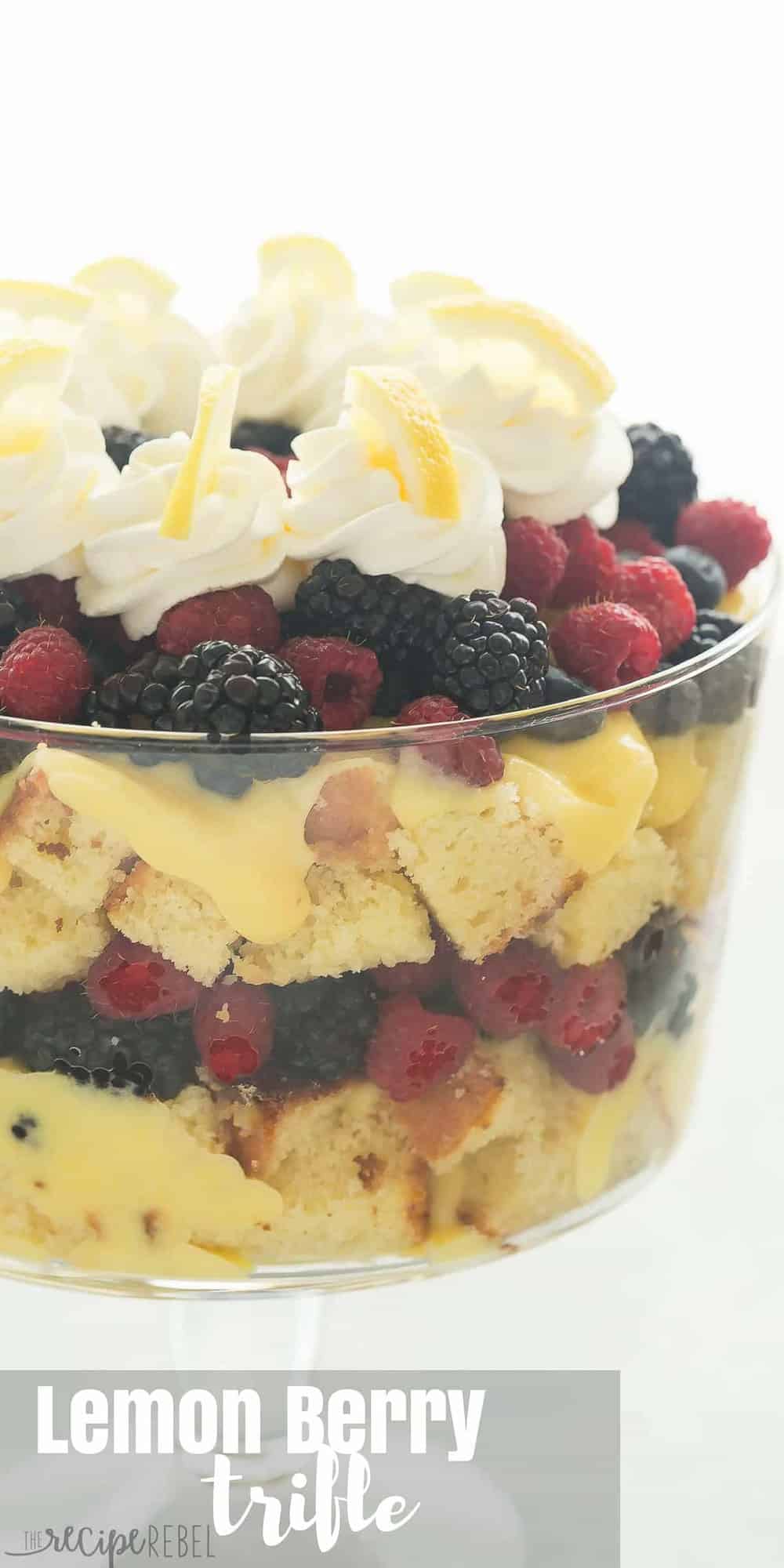 tall image of glass trifle bowl with lemon berry trifle topped with whipped cream