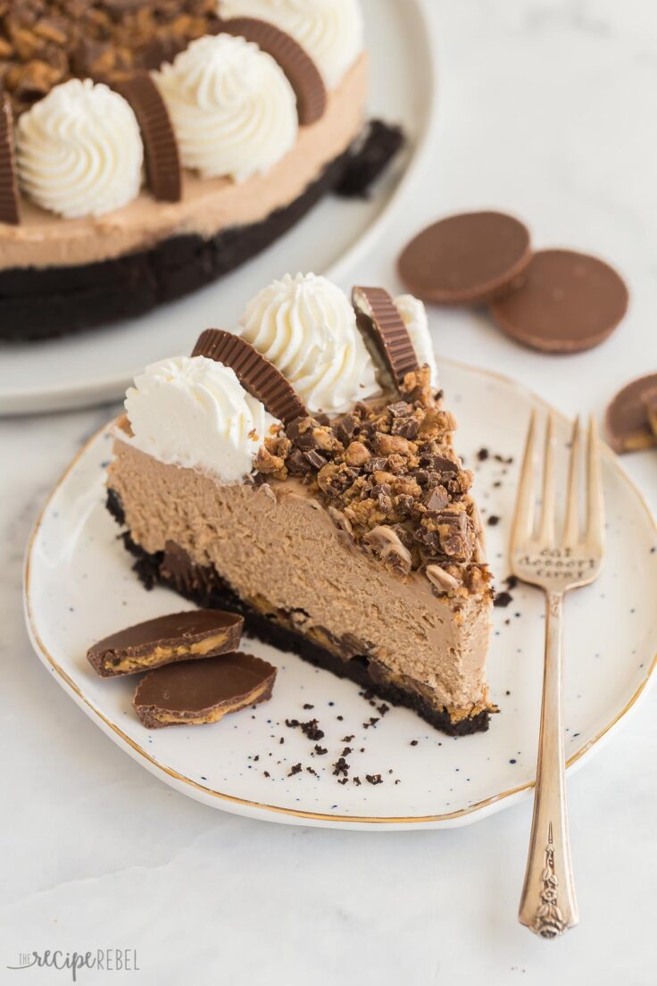 slice of no bake peanut butter cup cheesecake on white plate with fork
