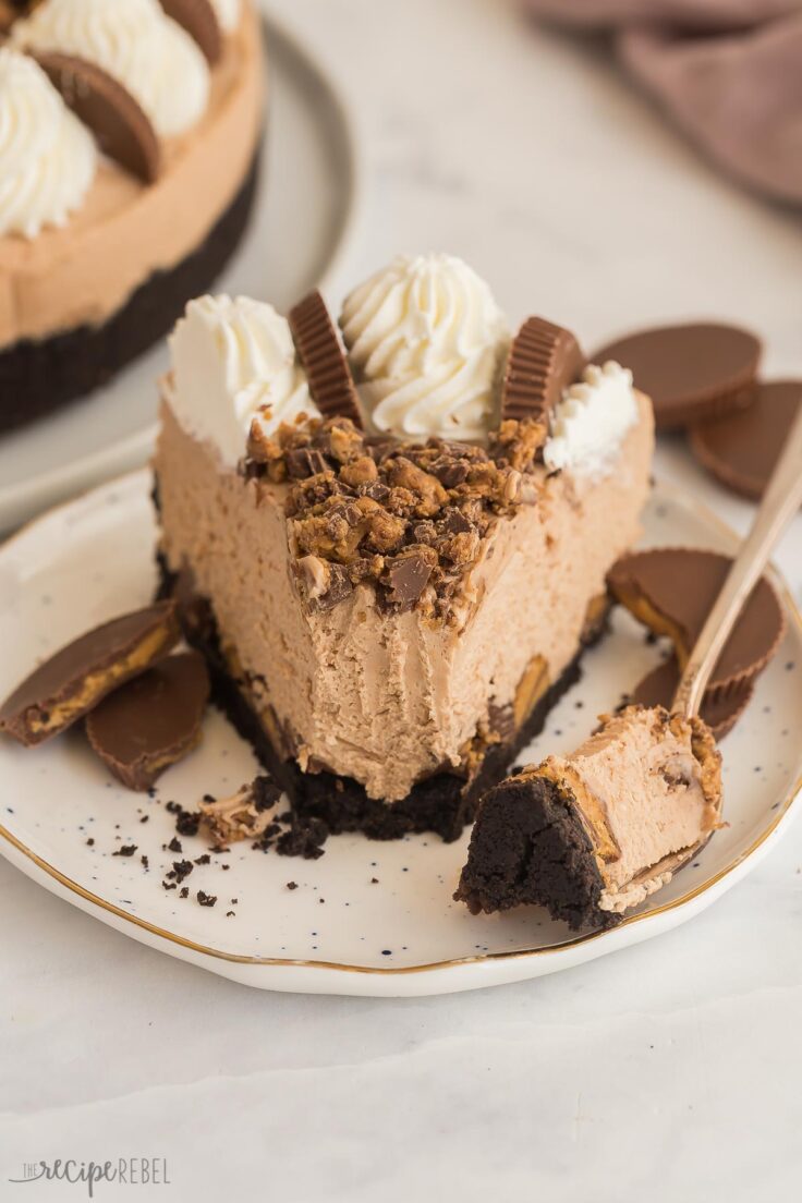 slice of peanut butter cup cheesecake with one bite missing