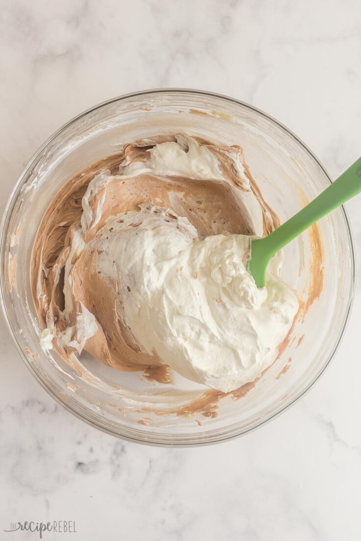 folding whipped cream into cheesecake filling