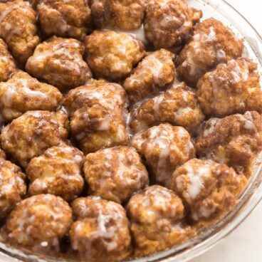 cinnamon roll bites with glaze in glass pie pan