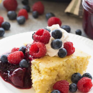 This easy Lemon Baked Pancake with Triple Berry Sauce is perfect for serving the brunch crowd at Mother's Day, Easter or Christmas -- no flipping required! My favorite way to make pancakes! Includes step by step recipe video. | baked pancakes | easy breakfast | holiday brunch | healthy recipe