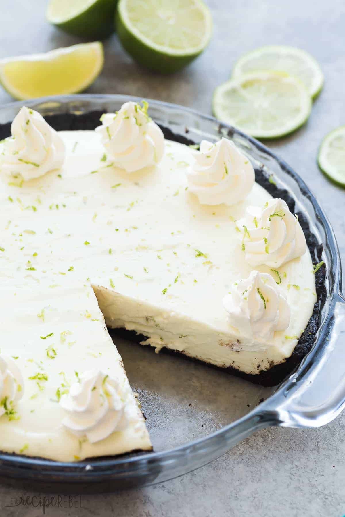 almost no bake key lime pie in glass pie plate with whipped cream and lime zest