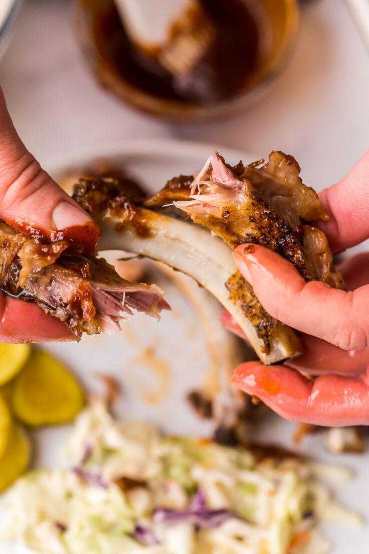 pulling meat off of crockpot ribs with fingers