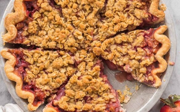 overhead image of whole strawberry pie cut in slices
