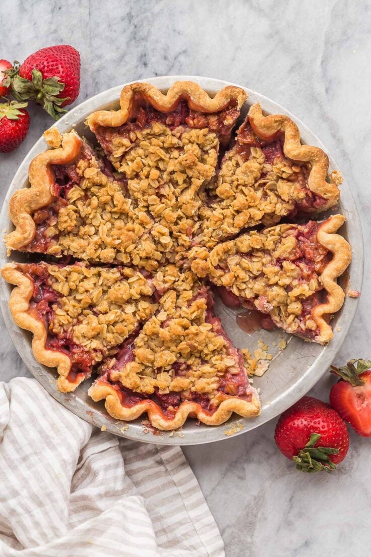 overhead image of whole strawberry pie cut in slices