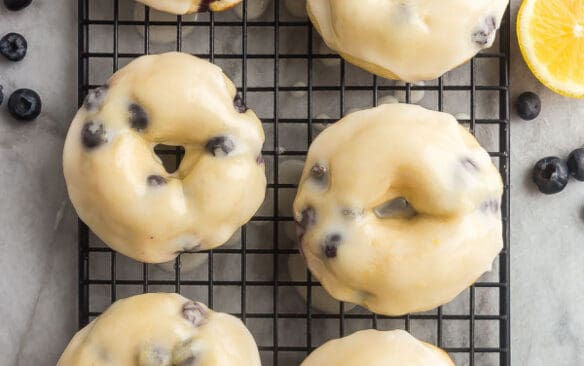 overhead image of 6 baked donuts with glaze