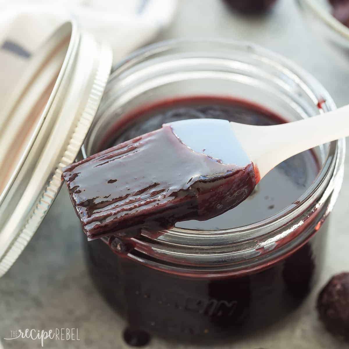 cherry bbq sauce in a small jar with basting brush resting on top