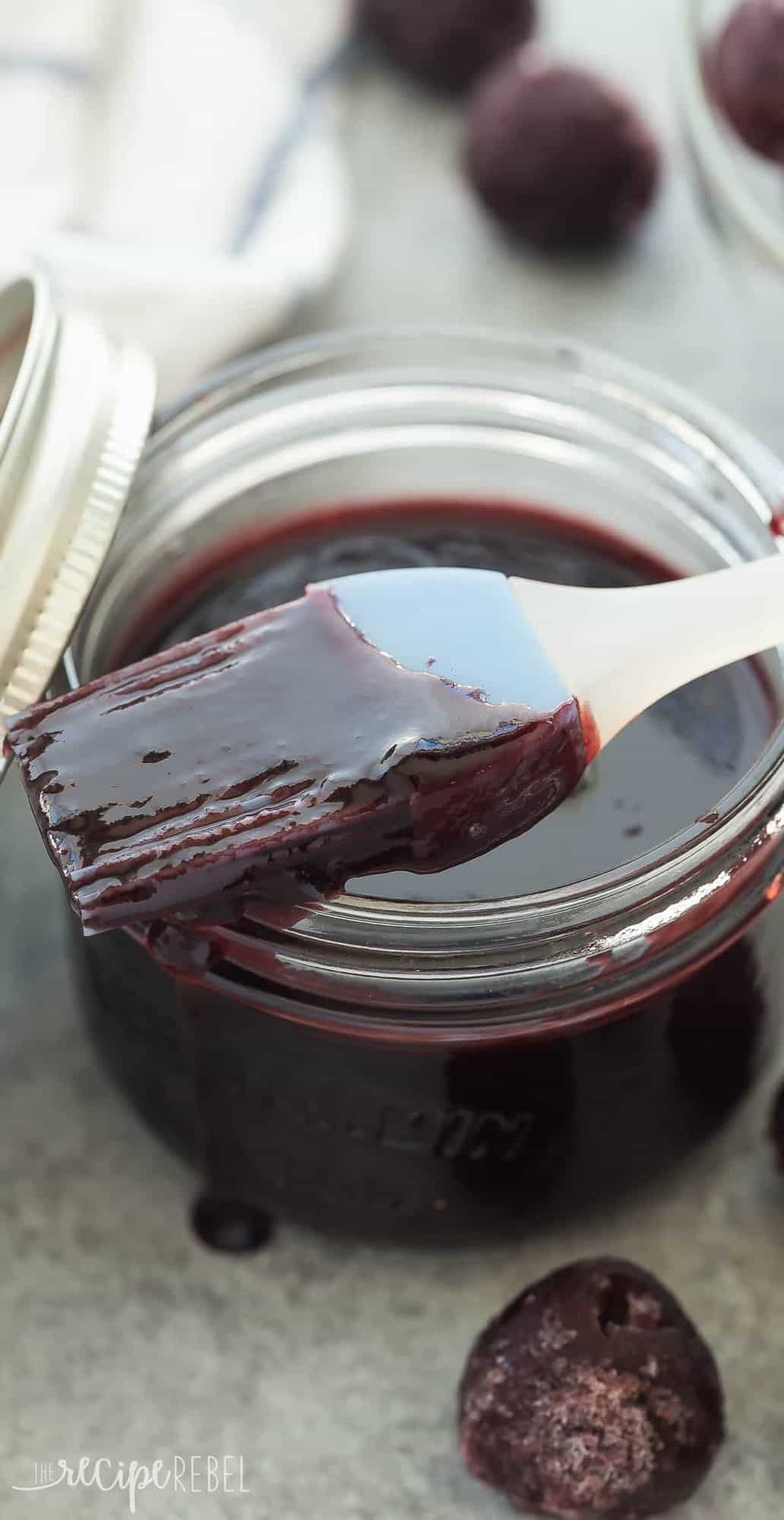 This Easy Homemade Cherry BBQ Sauce is made with fresh or frozen cherries and goes perfectly with chicken or pork. Make a big batch and keep it in the fridge or freezer all summer long! Includes how to recipe video long close up image of cherry bbq sauce in small jar with basting brush